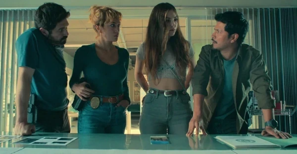 Characters of Acapulco Shore discussing around a table.